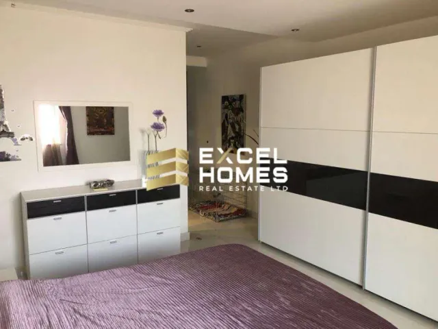 a bedroom with a bed, a dresser and a mirror 