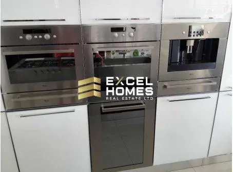 a kitchen with a stove, refrigerator, and microwave 
