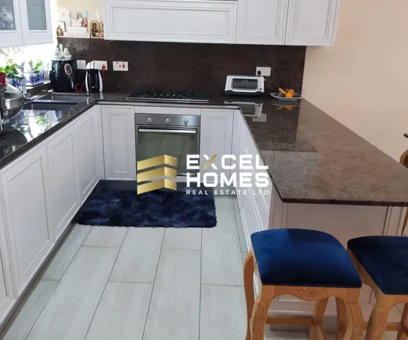 a kitchen with a sink, microwave, and a refrigerator