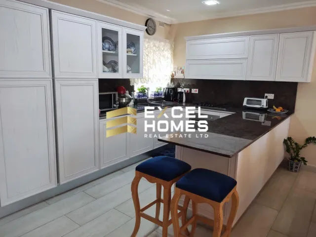 a kitchen with a table and a refrigerator