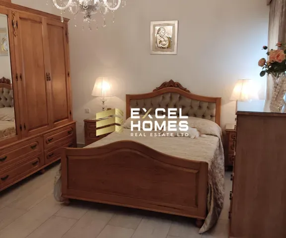 a bed with a wooden headboard and a white bedspread