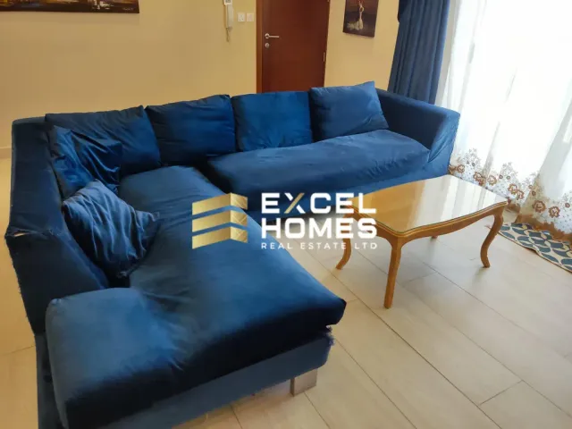 a couch with a blue couch cushions and a blue chair