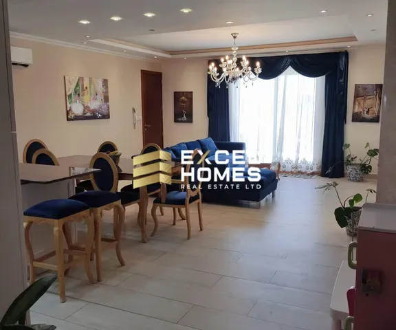 a room with a couch, chair, table and a television