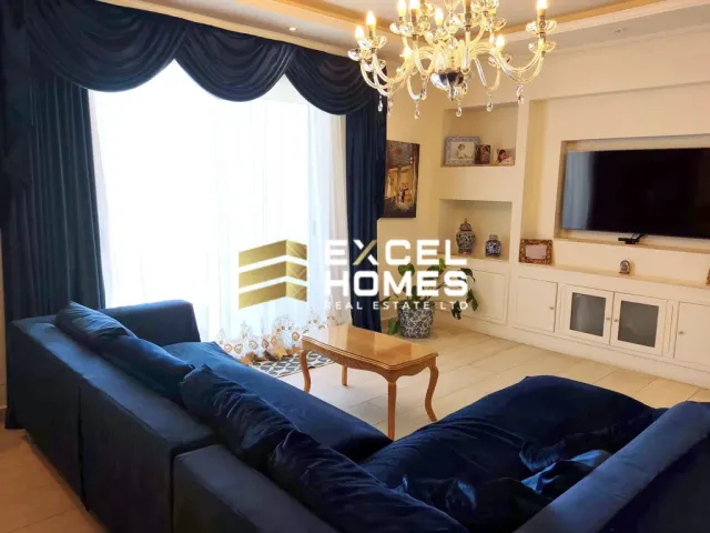 a living room with a couch, coffee table and a television