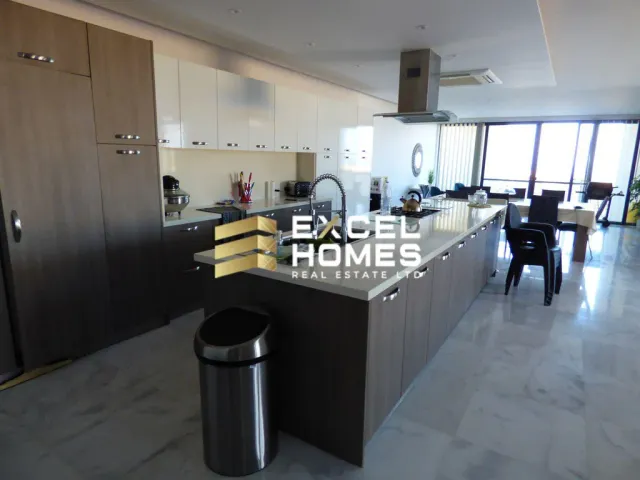 a kitchen with a large counter top and a large window