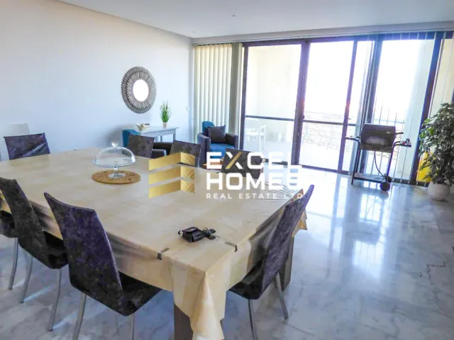 a dining room table with chairs and a table with a table cloth