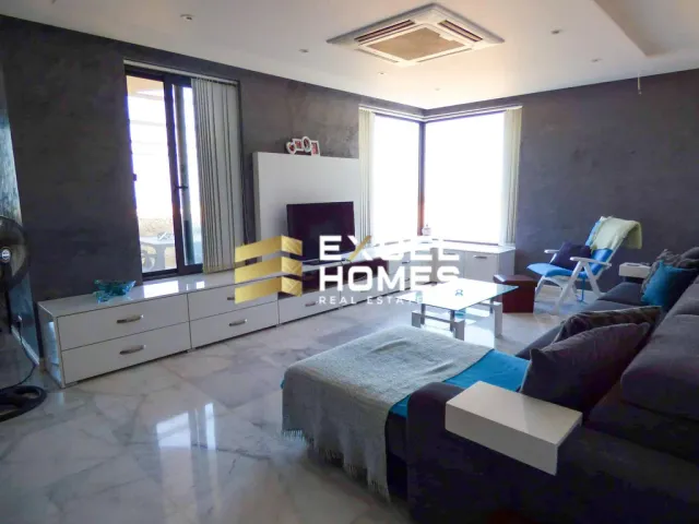 a living room with a couch, coffee table, and a television