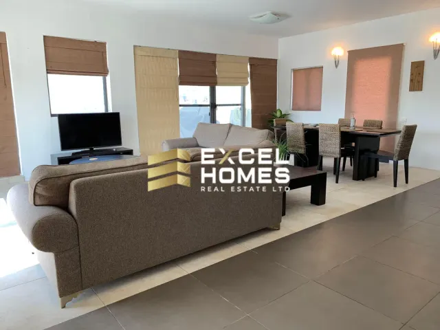 a living room with a couch, chair, and television 