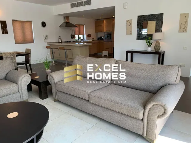 a living room with a couch, coffee table and a television 
