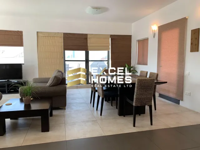 a living room with a couch, chairs, table and a tv 