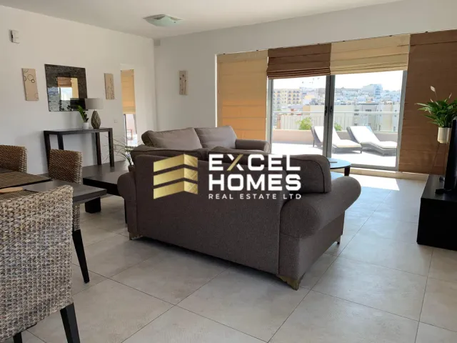 a living room with a couch, chair, and a table 