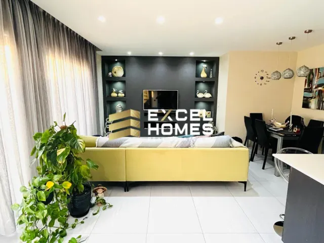 a living room with a large window and a large table