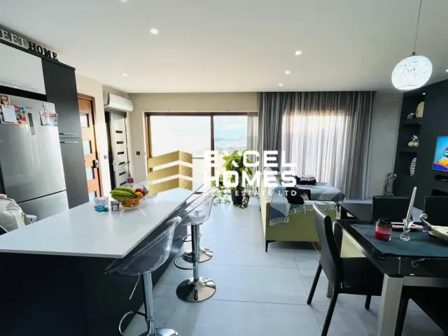 a kitchen with a table, chairs, and a refrigerator