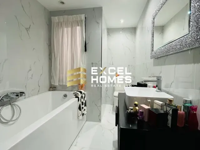 a bathroom with a bathtub, toilet, sink and mirror