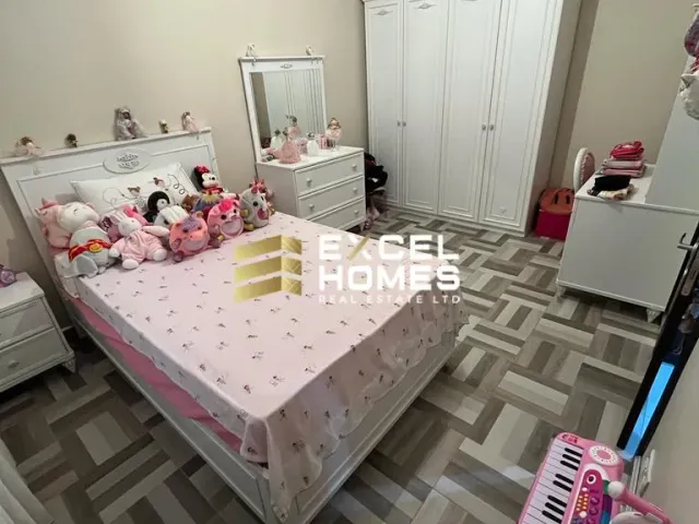 a small room with a pink table and a pink dresser
