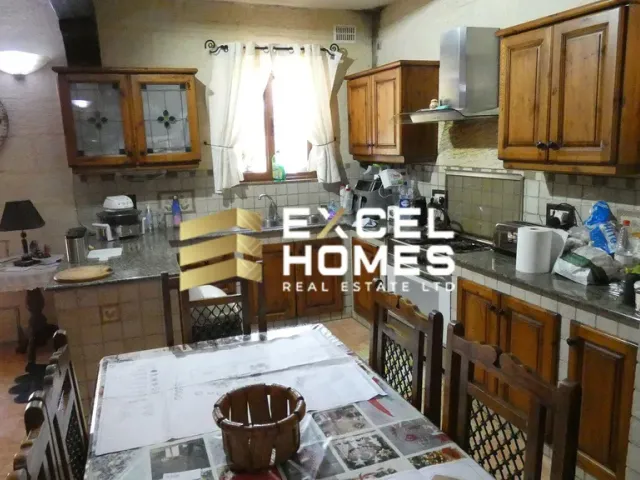 a kitchen with a stove, sink, and a refrigerator