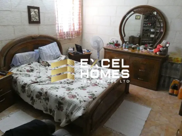 a bed with a white bedspread and a mirror