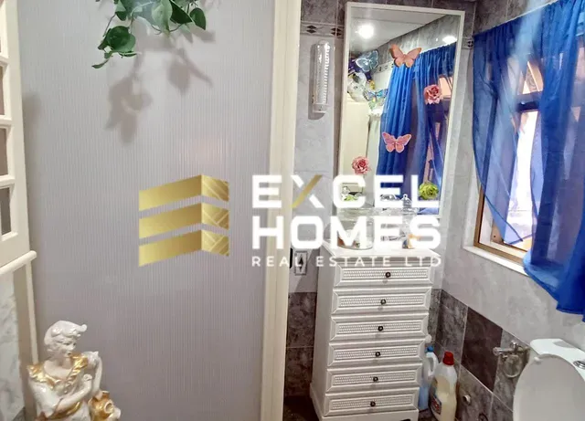 a bathroom with a shower curtain and a toilet 