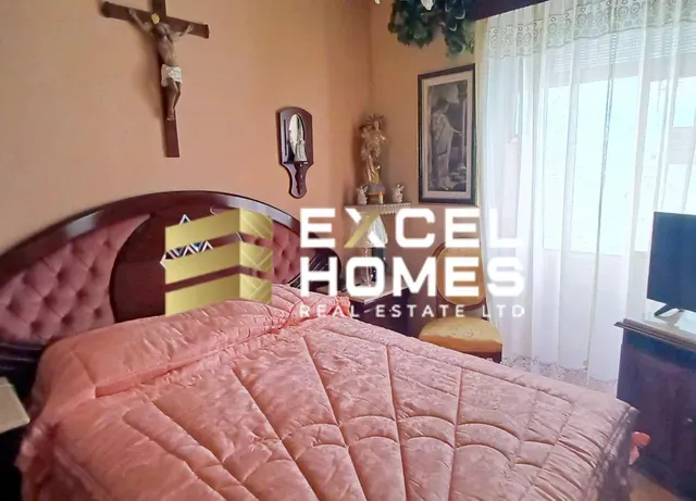 a bed with a bedspread and pillows in a bedroom 