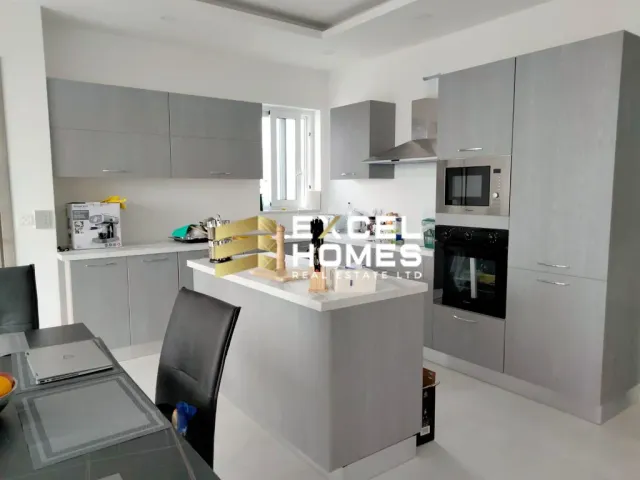 a kitchen with a sink, stove, refrigerator and a microwave