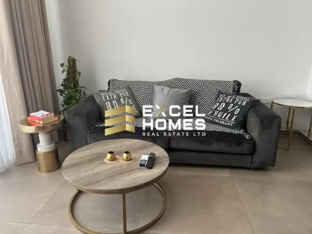 a couch with a remote control and a coffee table 