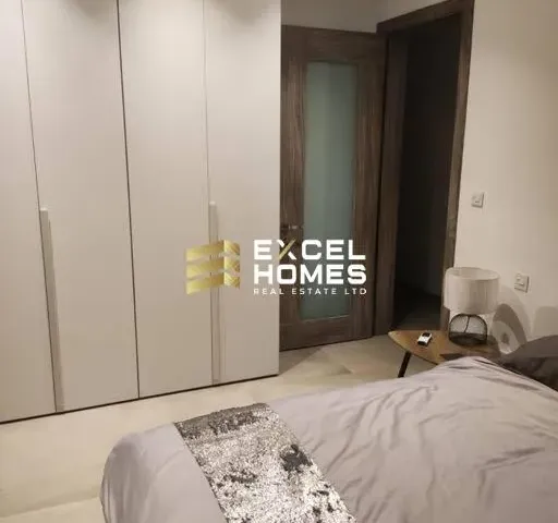 a bedroom with a bed, a mirror and a bookcase 