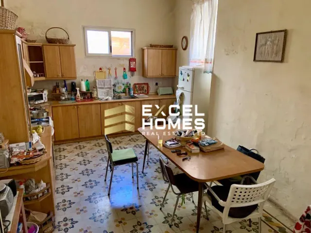 a kitchen with a table and chairs and a refrigerator