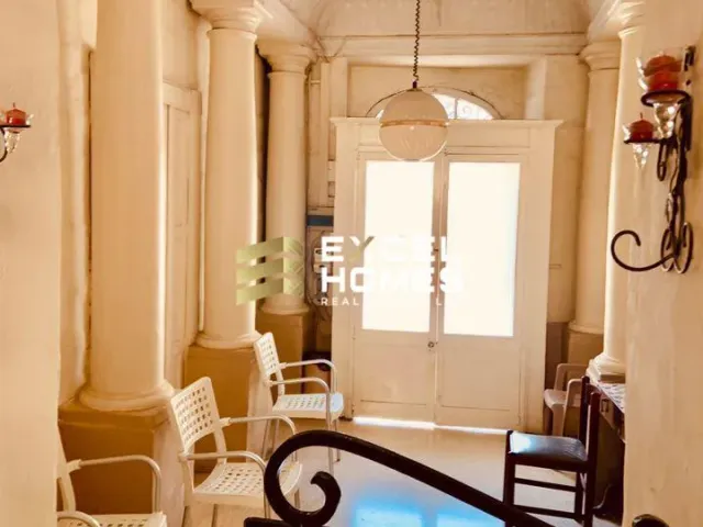 a living room with a table and chairs