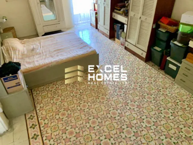 a bedroom with a bed, desk, and a rug