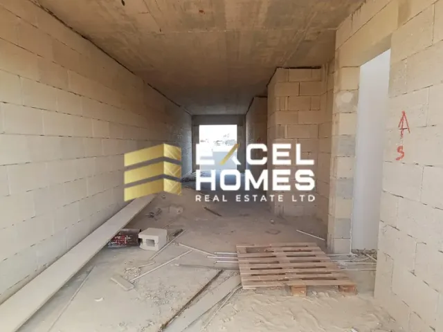 a room with a wall with a stairway and a wall with a brick wall