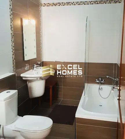 a bathroom with a toilet, sink, and mirror