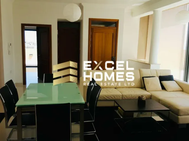 a living room with a couch, table, and a television