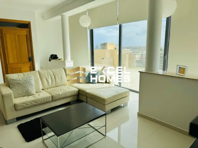 a living room with a couch, coffee table and a tv