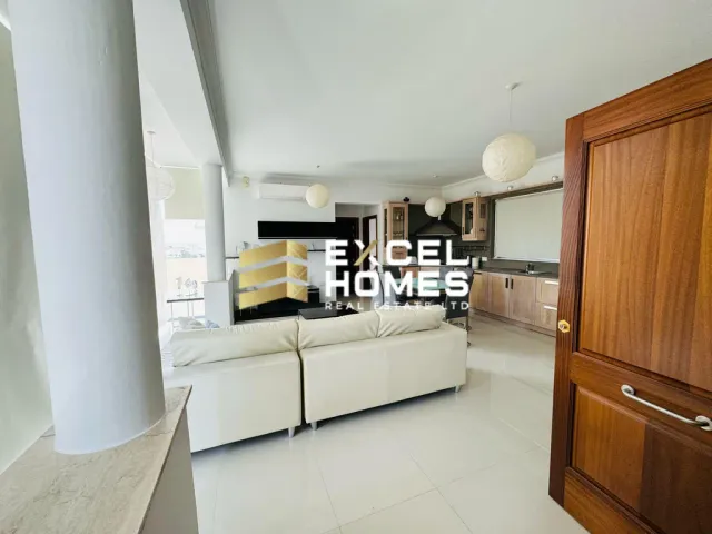 a living room with a couch, coffee table and a television