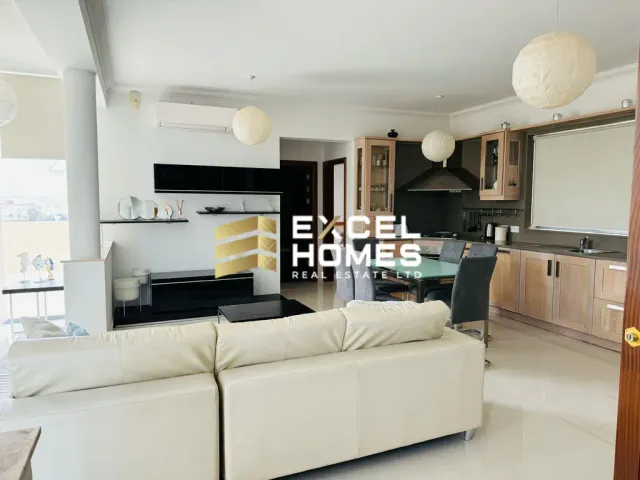 a kitchen with a white refrigerator and a white counter top