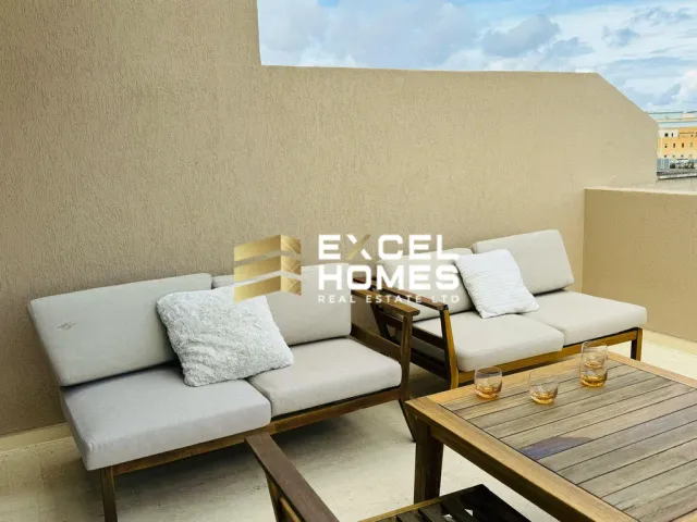 a living room with a couch, table and chairs