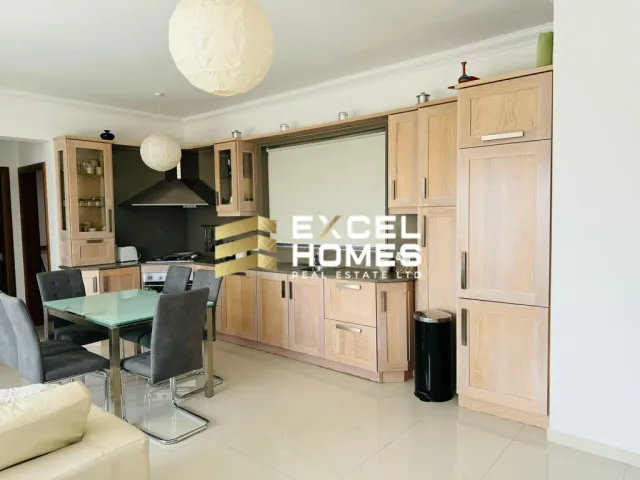a kitchen with a table and chairs and a refrigerator