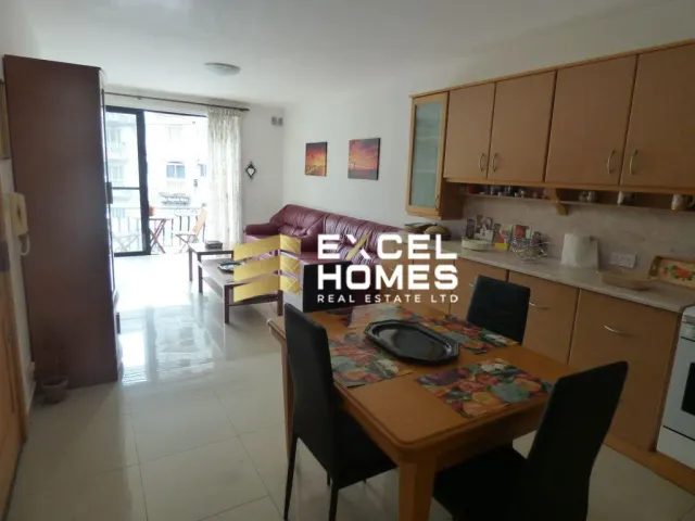 a kitchen with a laptop computer and a table