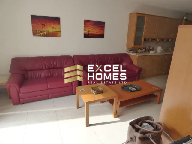a living room with a couch, coffee table, and a bookcase