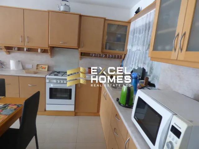 a kitchen with a microwave, stove, and a sink