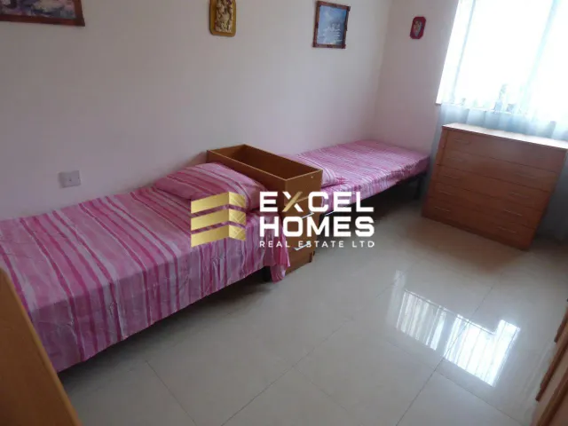 a bedroom with a bed and a desk