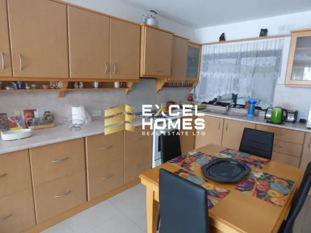 a kitchen with a stove, a sink, and a refrigerator