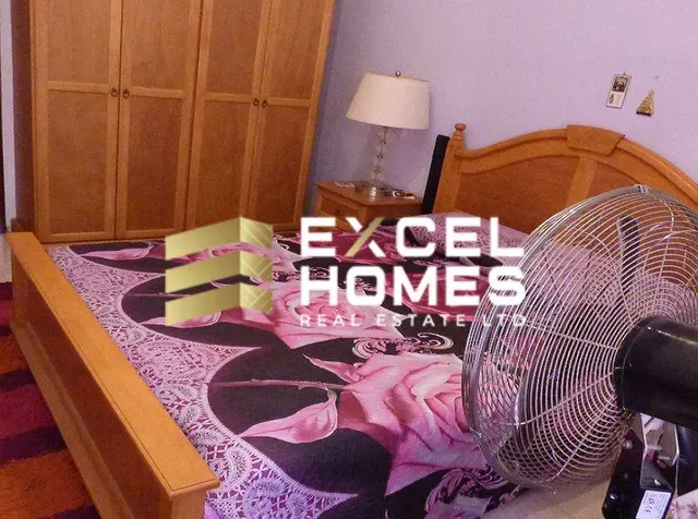 a bed with a bedspread and a lamp