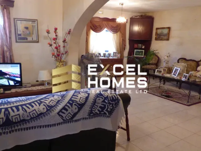 a living room with a television and a bed