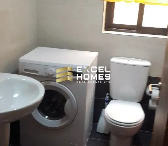 a white toilet sitting next to a white sink