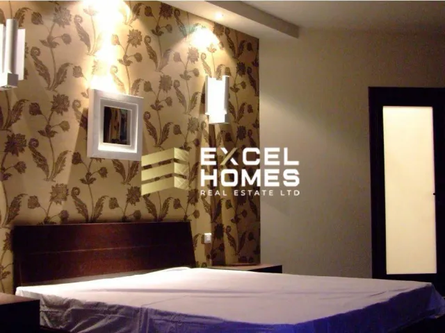 a bedroom with a bed, a mirror and a window 