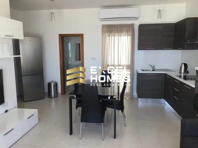 a kitchen with a table and chairs and a refrigerator