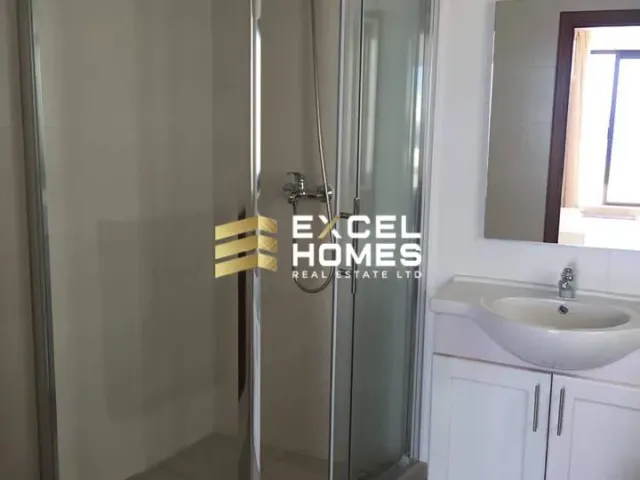 a bathroom with a shower, sink, and mirror