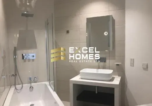 a bathroom with a sink, mirror, and bathtub