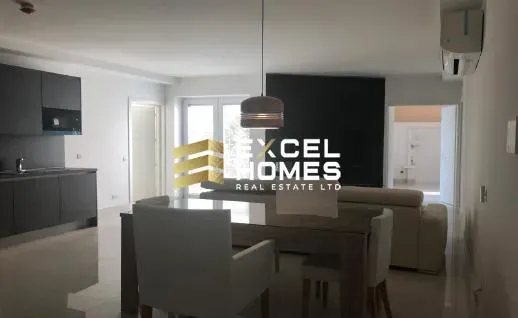 a kitchen with a table and chairs and a refrigerator